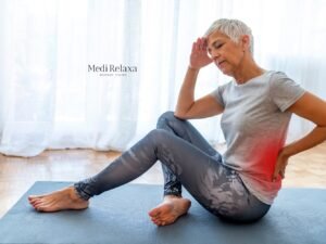 vrouw in sportkledij op yoga mat met 10 oefeningen tegen lage rugpijn