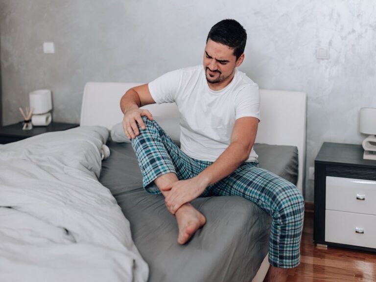 man in pyjama met spierpijn hele lichaam en moe