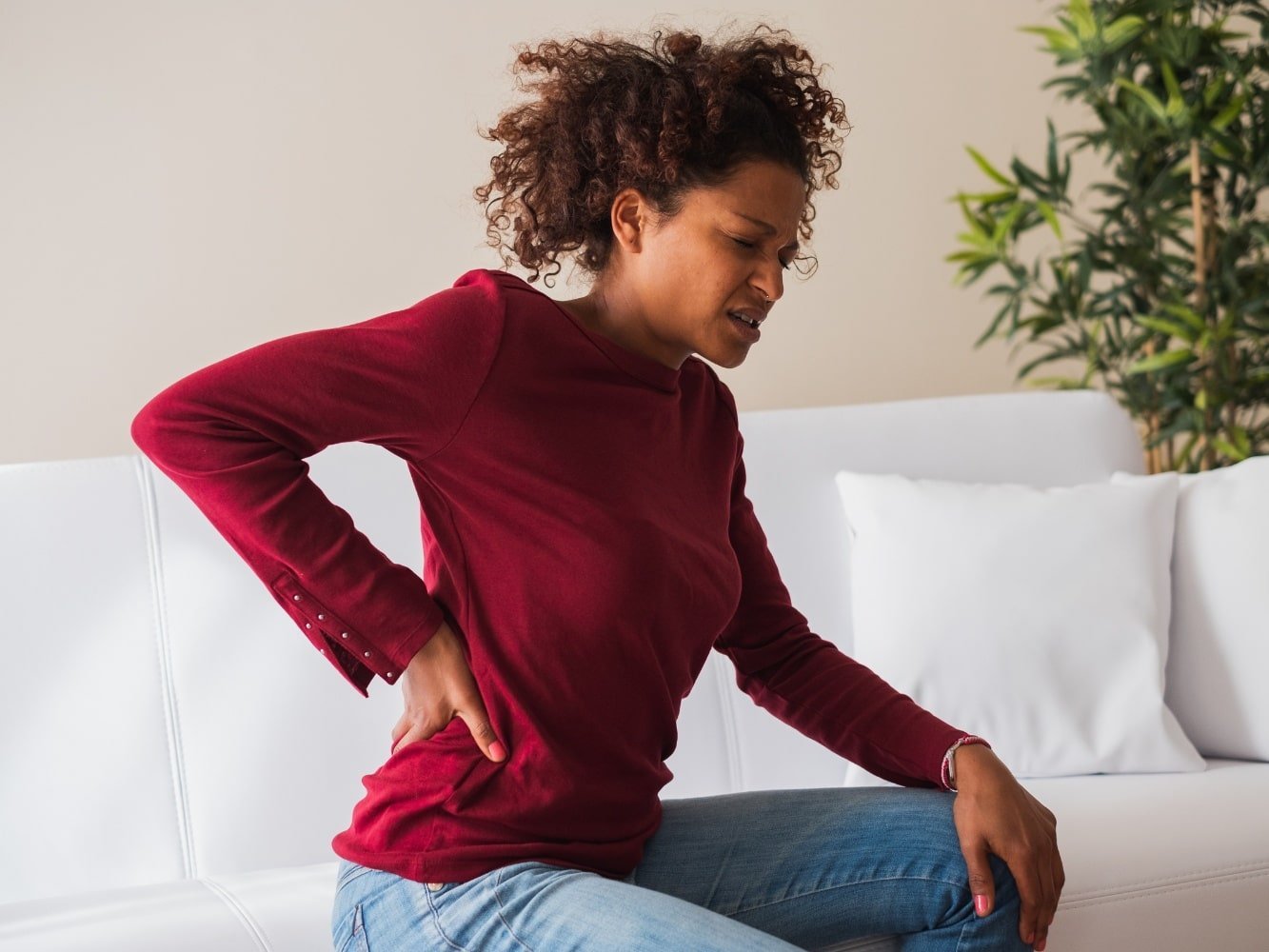 woman on seat with muscle and joint pain everywhere